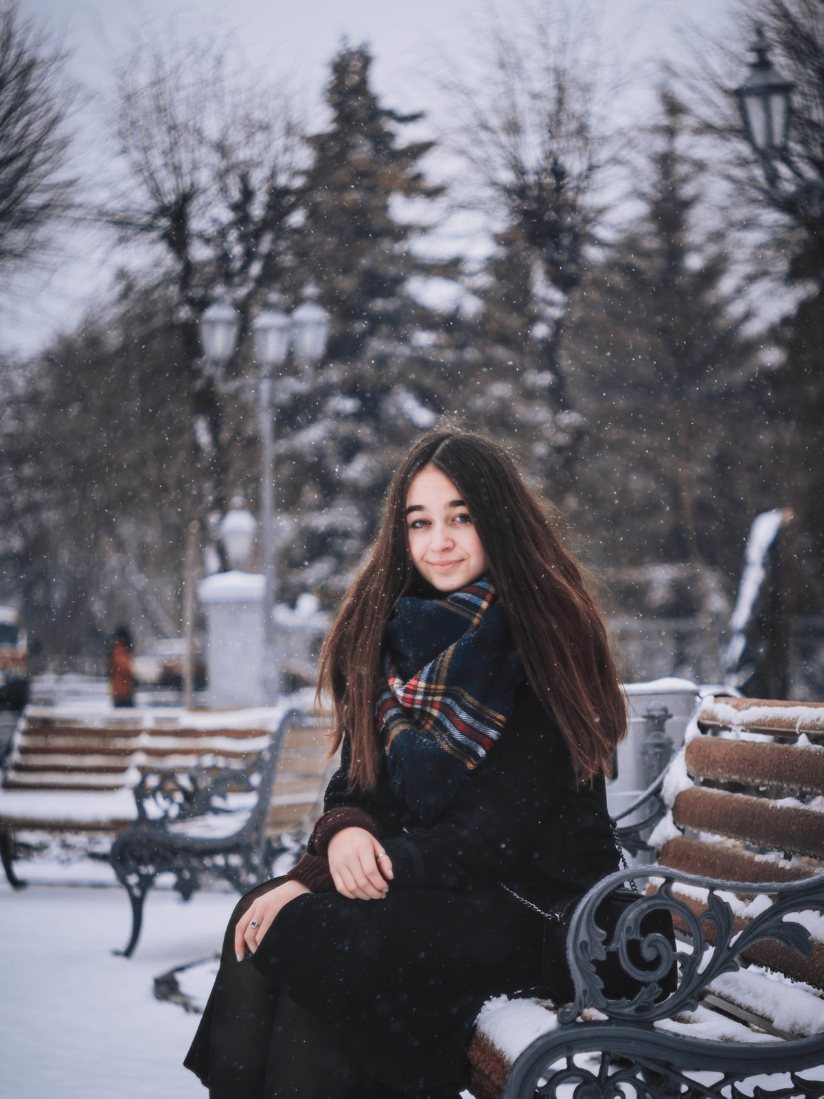 Mädchen auf einer Bank im Schnee