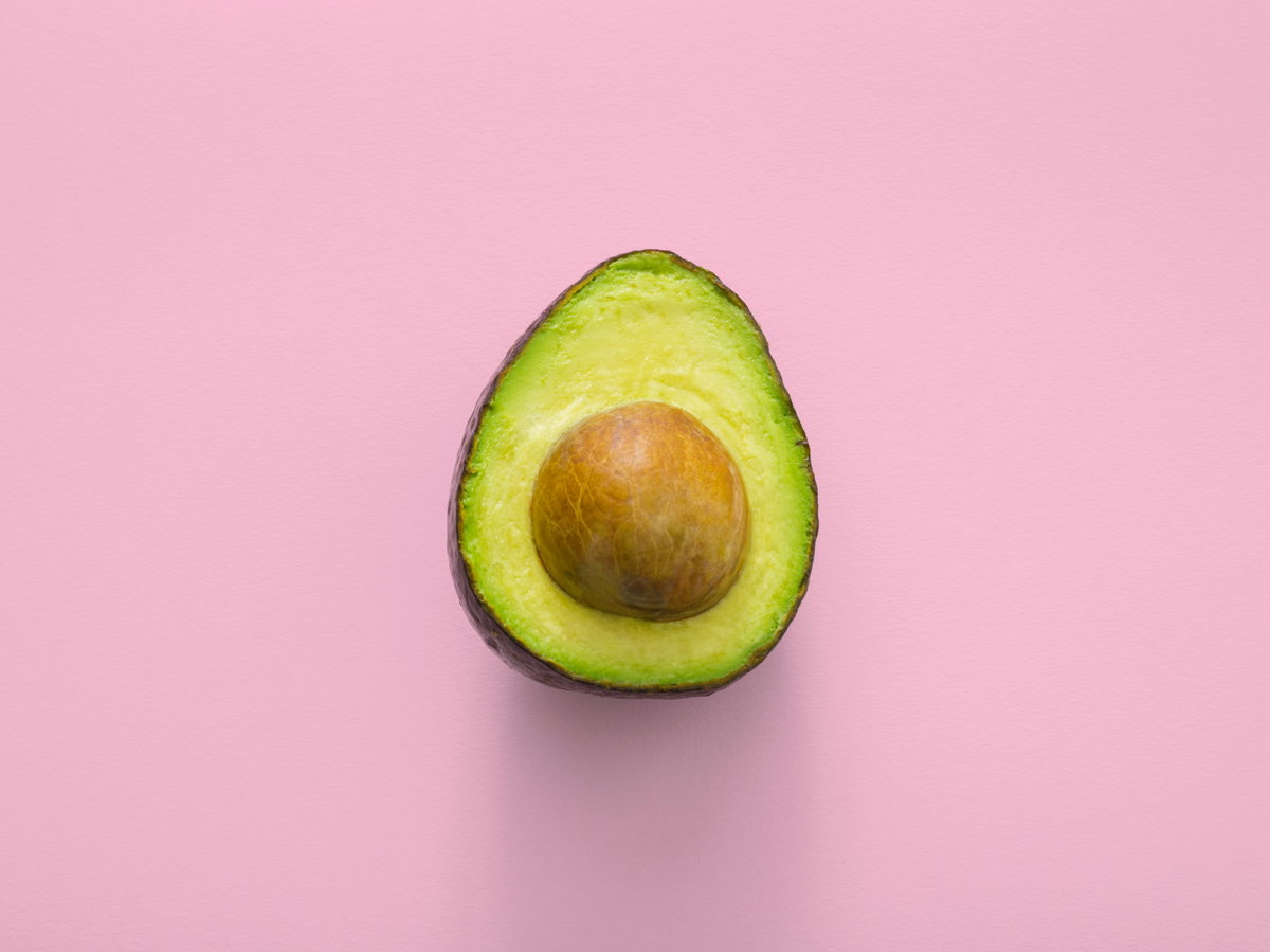 Avocado vor rosa HIntergrund